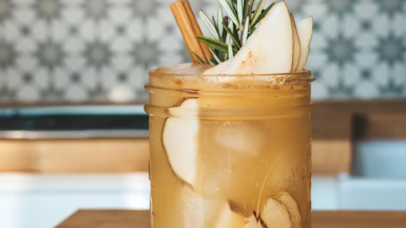 A mixed drink in a mason jar glass